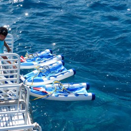 a man riding on the back of a boat in the water