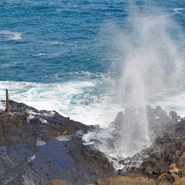 a man riding a wave on top of a mountain