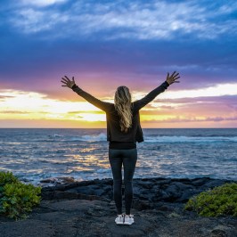 a person standing in front of a body of water
