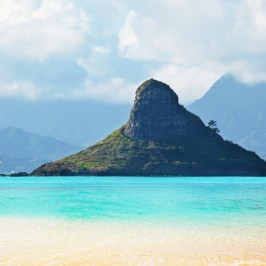 a body of water with a mountain in the background
