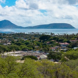 a large body of water with a mountain in the background