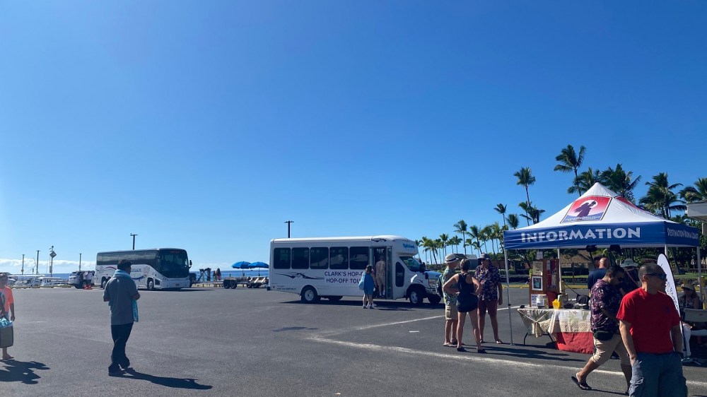 a group of people standing in a parking lot