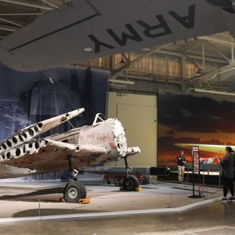 a group of people standing around a plane
