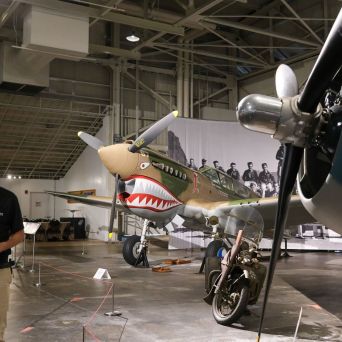 a man standing next to a plane