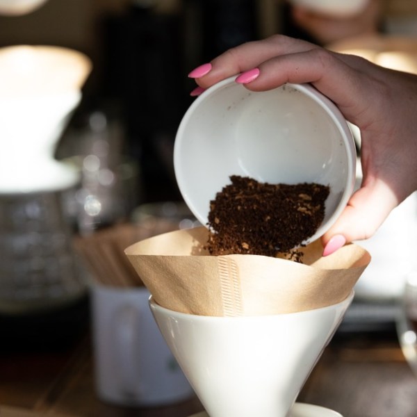 a hand holding a cup of coffee