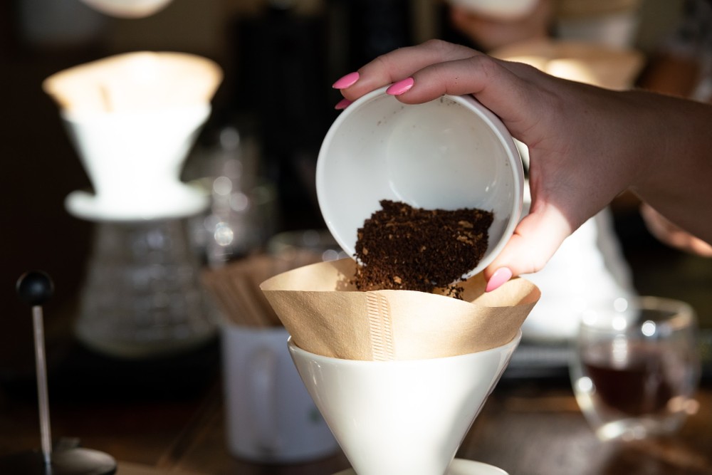 a hand holding a cup of coffee