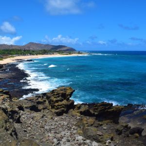 a rocky beach next to a body of water