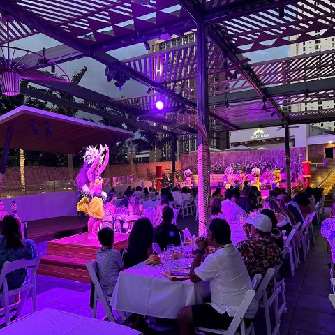 a group of people performing on stage in front of a building