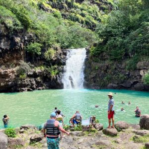 a group of people standing next to a body of water