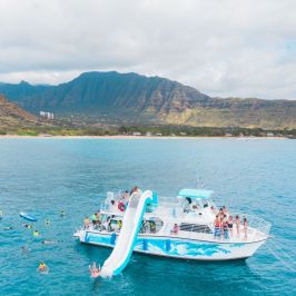 a small boat in a body of water with a mountain in the background