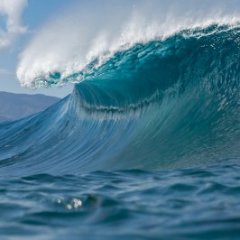 a man riding a wave on a surfboard in the ocean