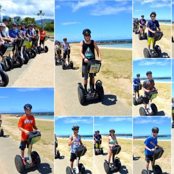 People riding Segways on a sunny beachside path, wearing helmets.